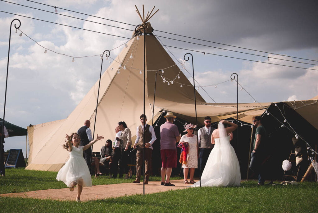 Wedding guests outside a tipi