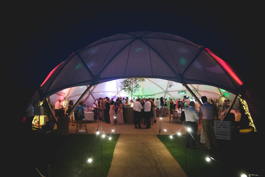 Night time photo of a wedding geodome, used instead of a marquee